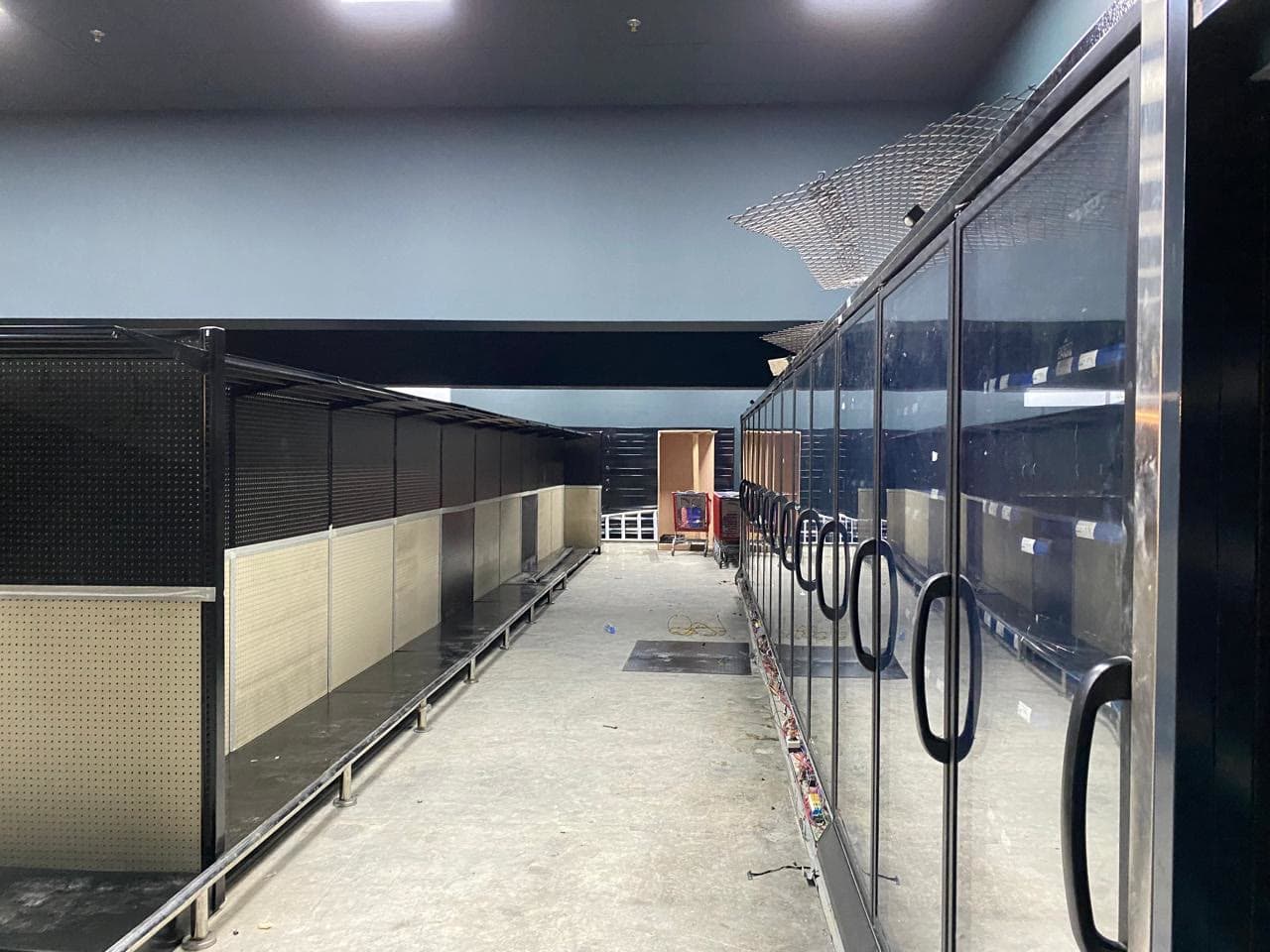 Row of glass-door chillers along the back wall
