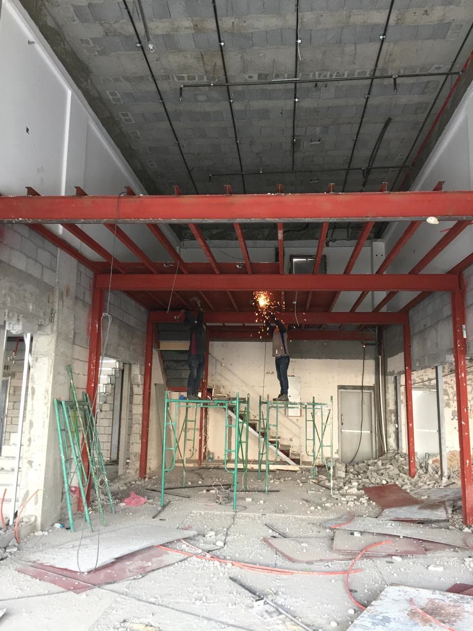 Red structural steel mezzanine frame during construction