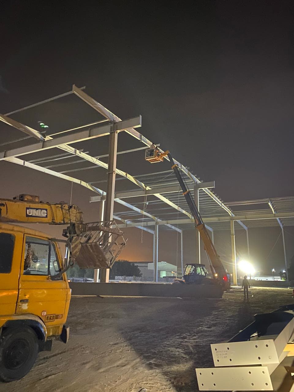 Night-shift crane erecting the steel frame